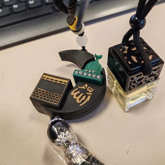 Two decorative necklaces on a desk with a keyboard in the background