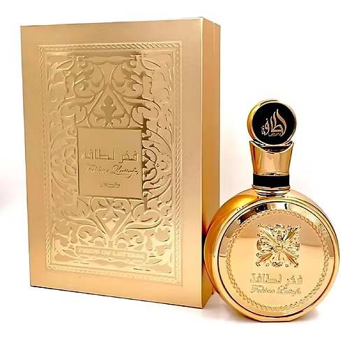Gold perfume bottle and packaging with intricate designs on a white background