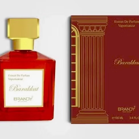 Red perfume bottle with gold cap and matching box on a white background