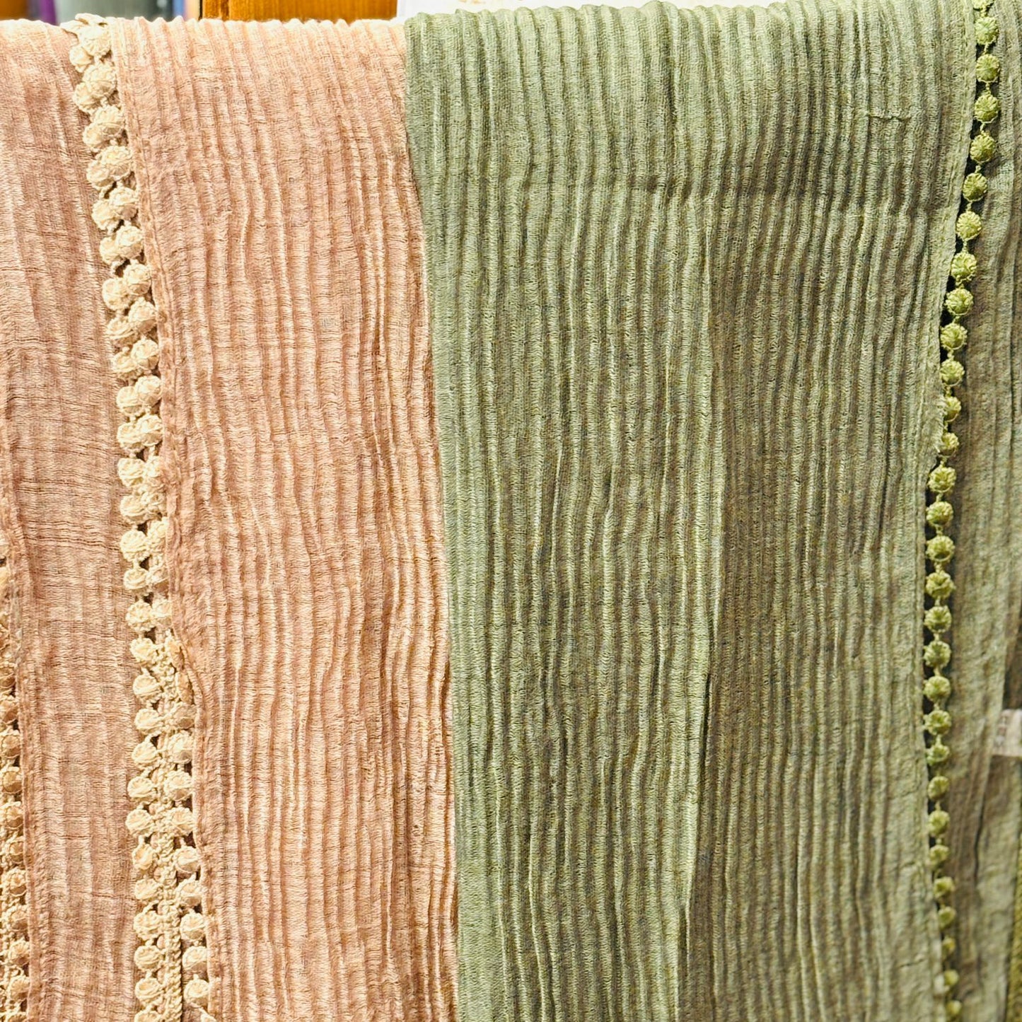 Close-up of textured fabric with a pink and green color scheme.