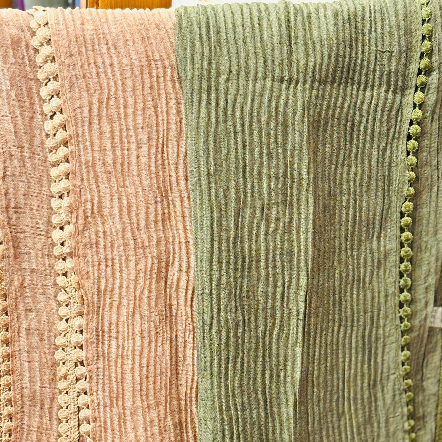 Close-up of textured fabric with a pink and green color scheme.