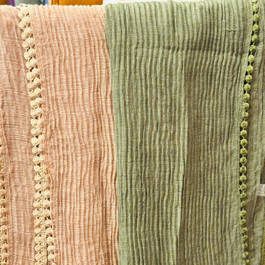Close-up of textured fabric with a pink and green color scheme.